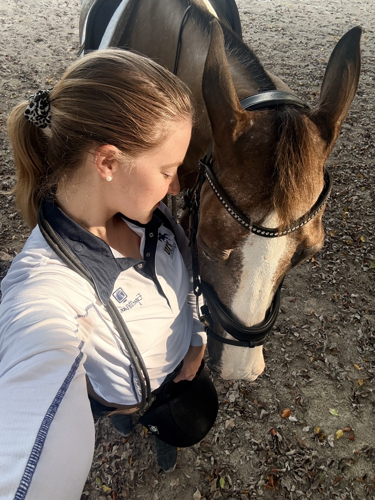 Shelby with a horse outdoors