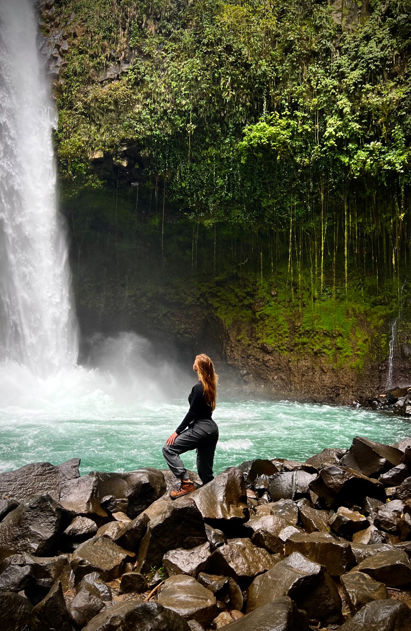 Shelby exploring beside a waterfall