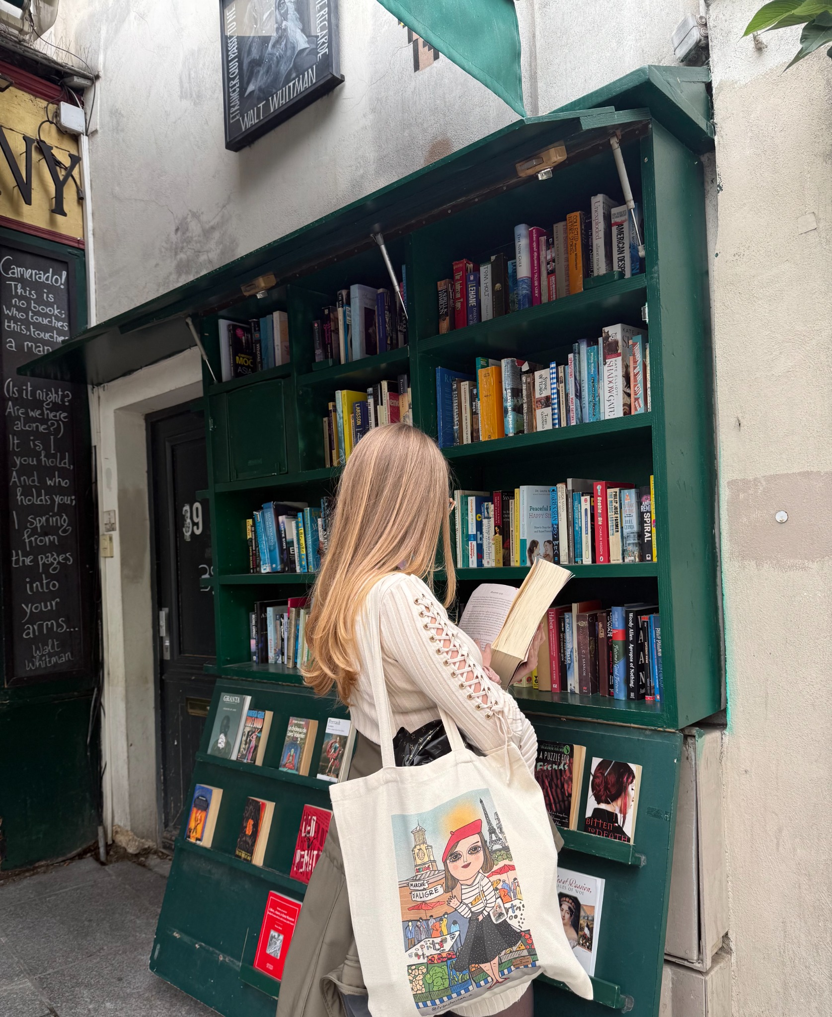 Shelby browsing books at an outdoor bookshop